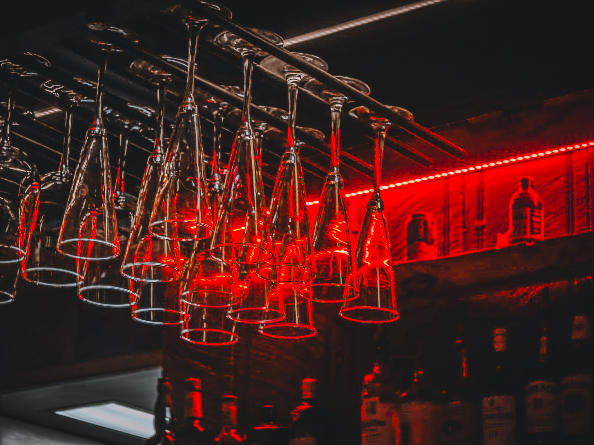 Bar interior — wine glasses lit by red neon, Flagstaff Arizona