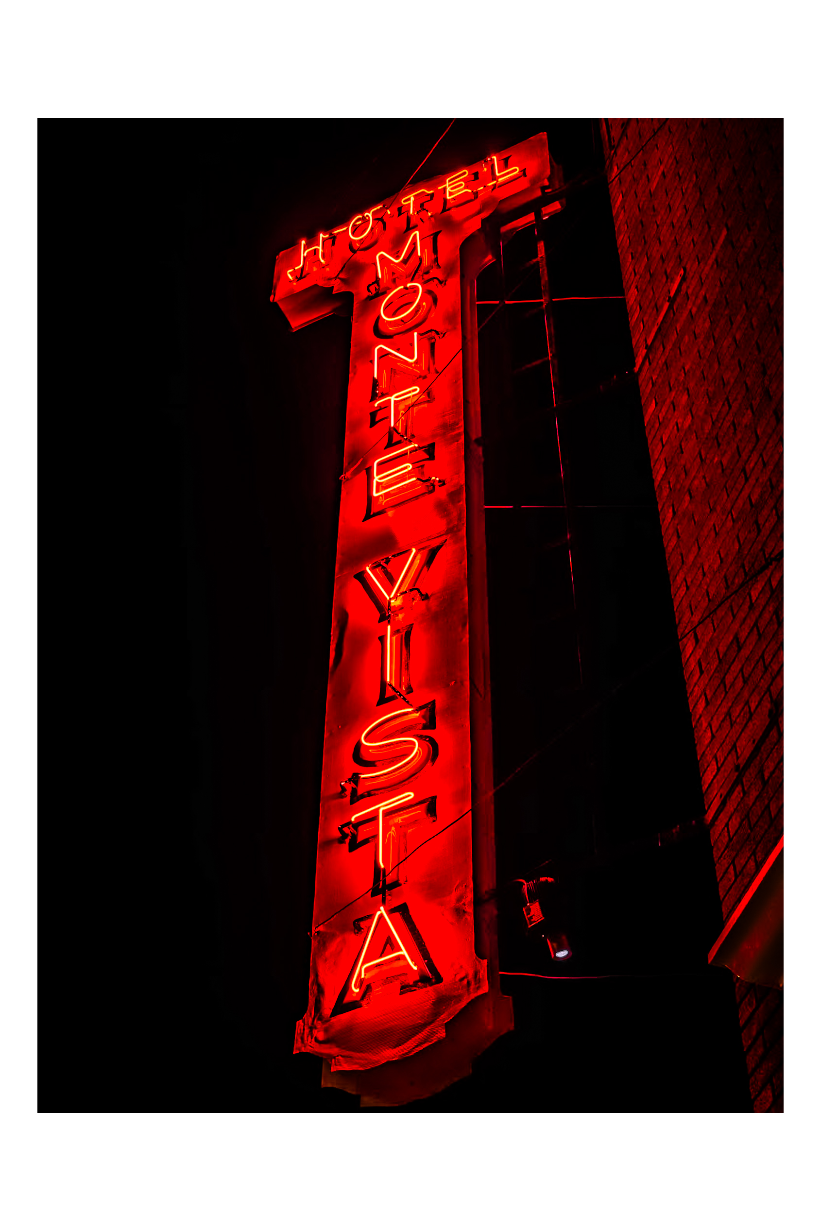 Hotel Monte Vista neon sign blazing vermillion red at night — downtown Flagstaff, Route 66