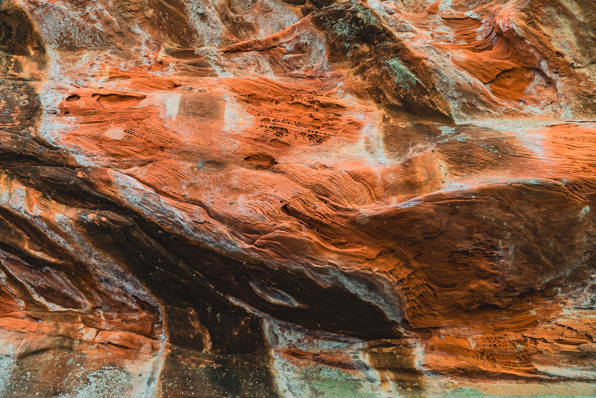 Iron oxide layers in Sedona sandstone — geological time rendered in flowing red and amber